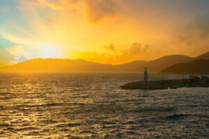 A breathtaking sunset at the lighthouse in Kas, Antalya, Turkey, captured over the sea.