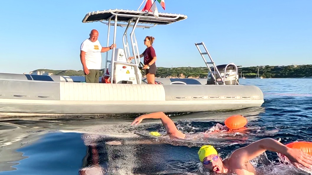 Escort boats and swimmers move together throughout the Strait of Bonifacio crossing.